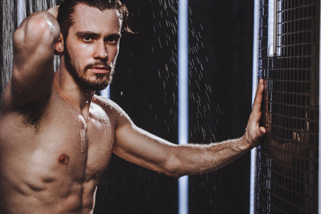 young sportsman is taking a shower after joggingの写真素材