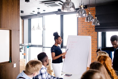 chief of team pointing at flipchart and explaining the structure of businessの写真素材