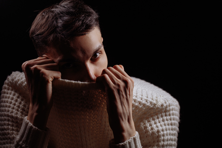 Studio shot of a handsome young male model wearing white T-shirt and sunglassesの写真素材