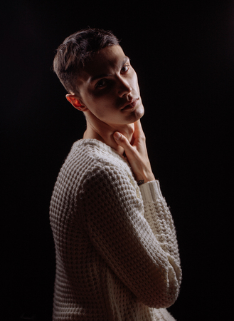 Studio shot of a handsome young male model wearing white T-shirt and sunglassesの写真素材