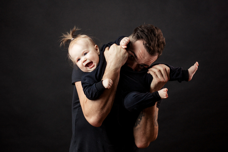 handsome father holding his cute newborn babyの写真素材