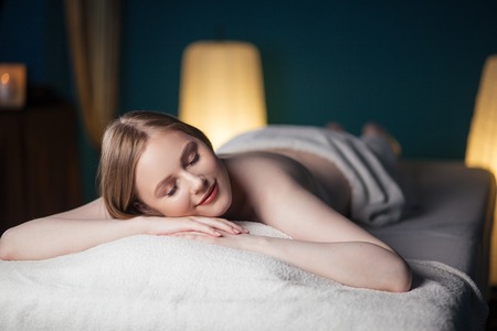 Half naked woman resting after massageの写真素材