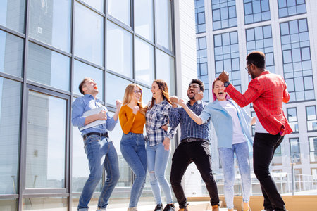 Group of multi ethnic youngsters chilling in urban outdoor background
