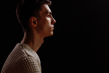 Studio shot of a handsome young male model wearing white T-shirt and sunglassesの写真素材