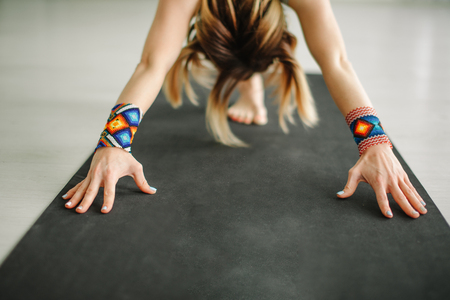 fitness woman stretching her hands exercising yoga in hallの写真素材