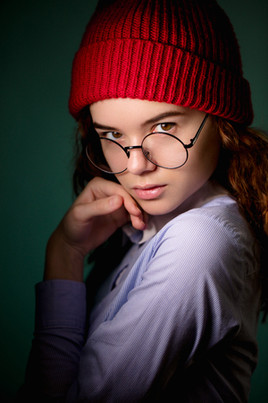 stylish street girl in shirt and red cap posing to the cameraの写真素材