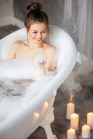 pleasant girl enjoying bubble bath