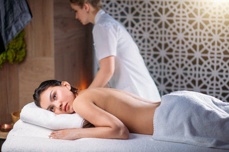 close up shot having rest client with female masseur on the black backgroundの写真素材