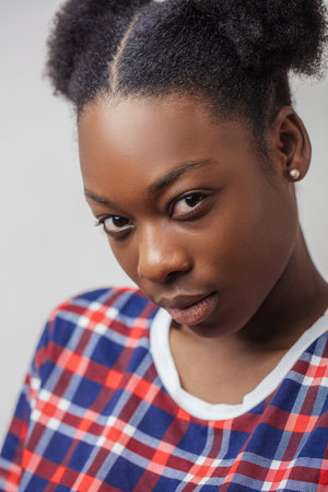 close up cropped photo of Afro woman with serious look.の写真素材