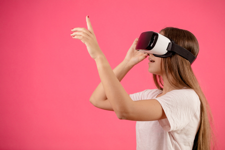 woman with long hair and vr glasses is rising her finger .a short in the darkの写真素材