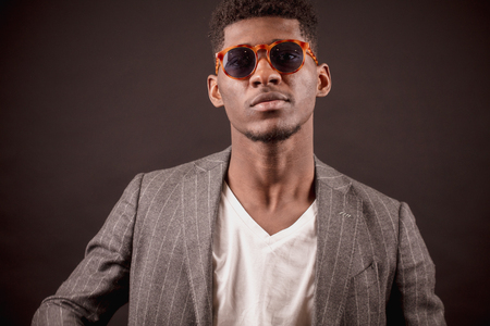 stylish young Afro businessman wearing sun glassesの写真素材
