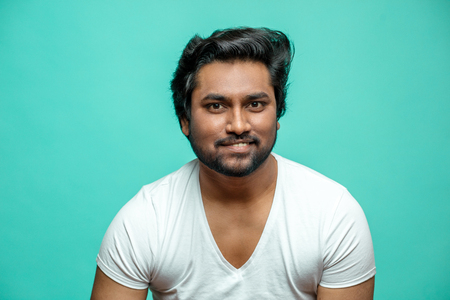 close up portrait of cunning Indian male pretending that he is smilingの写真素材