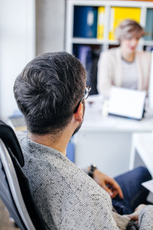 closeup portrait of boss keeping watch over his nice colleague