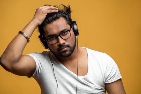 close up portrait of stylisg indian hipster in headphonesの写真素材