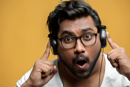 Indian guy has found his favourite song in the playerの写真素材