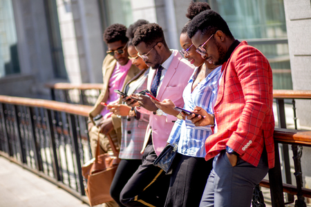 business people using their gadget in the streetの写真素材