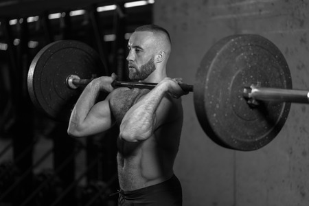 black and white photo. cross fit training with barbellの写真素材