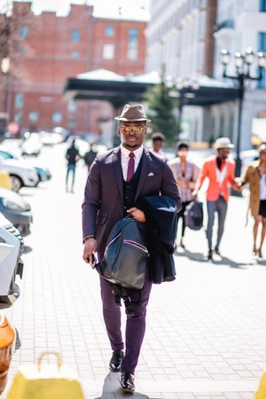 confident successful businessman strolling on the street