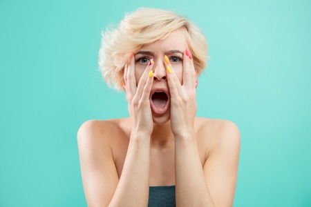 closeup portrait a woman with wode open mouth dressed casually looking surprisedの写真素材