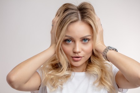 Portrait of sexy young woman with beautiful curly blond hairの写真素材