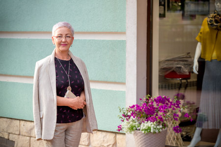 awesome positive woman standing next to the store with trendy clothes