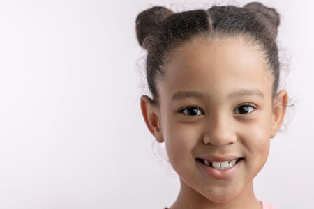awesome African kid with positive expression is looking at the camera