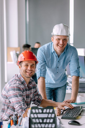 handsome smiling architects working in the office building