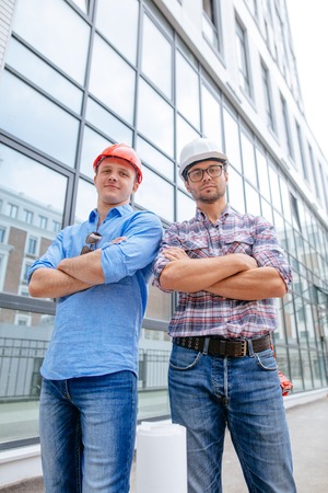 confident architects are standing with folded armsの写真素材