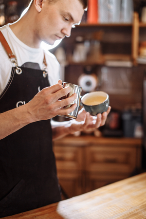 handsome man is making latteの写真素材