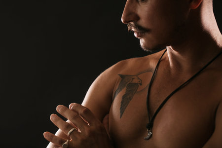 Strong Athletic Sexy Muscular Man on Black Background