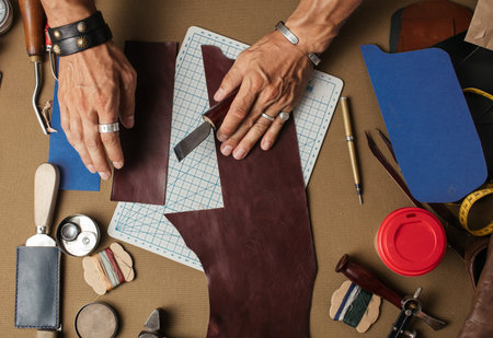 Working process of producing hand made leather wallet in the leather workshop.
