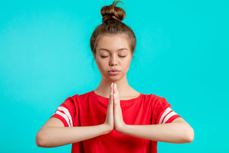 beautiful girl with hairbun is concentrated on yoga