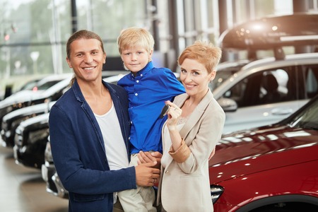 automobile sales centre. young family with child boy in car sellの写真素材