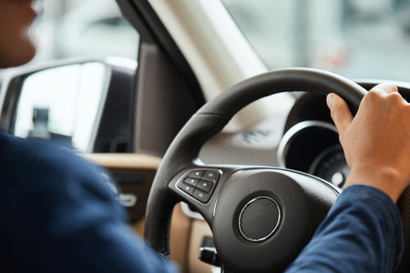 elegant happy man in good new car in sale centreの写真素材