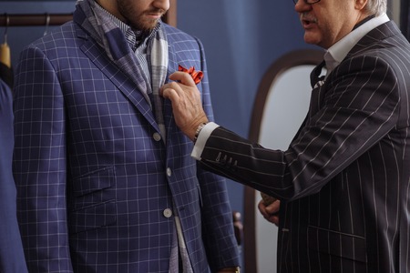 Tailor with client in atelier. Sewing custom made suitの写真素材