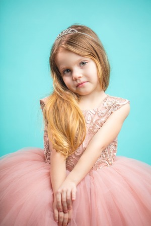 Portrait of cute happy charming little girl in princess dressの写真素材