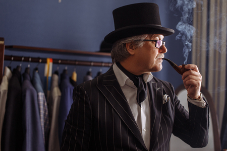 Portrait of posh mature gentleman visiting a tailors shopの写真素材