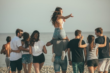 happy mans and womans walk at the beach Group of friends enjoying beach holidaysの写真素材