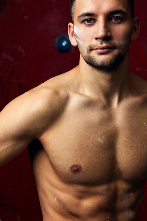 Closeup portrait of rock climber against artificial wall for climbingの写真素材