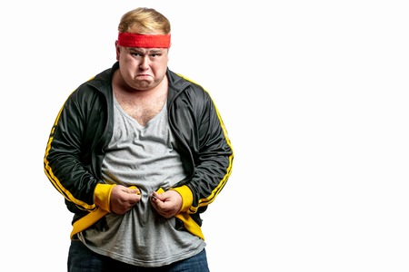 Middle age man with big belly trying to fasten spot jacketの写真素材