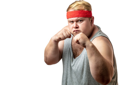 Fat man, feeling furious, in fight stance ready to hit, white isolated studioの写真素材