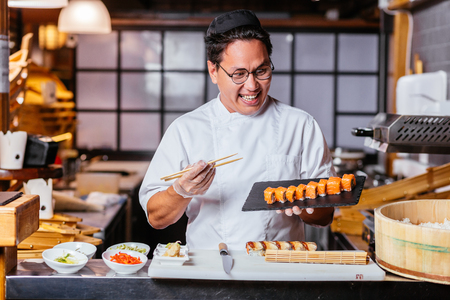 hungry chef is looking at yummy rollの写真素材