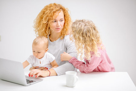 beautiful woman and blond girl are talking to each otherの写真素材