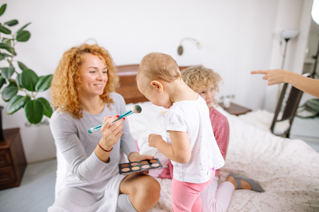 mommy preparing her children for a partyの写真素材