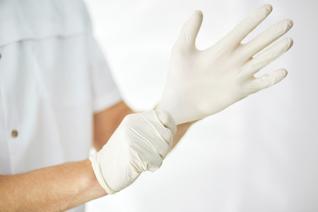 sterilized surgical gloves. close up cropped photo. tool for doctorsの写真素材