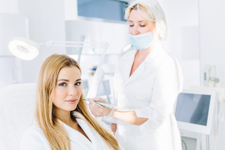 Blonde woman undergoes a procedure of facial gas-liquid oxygen peeling