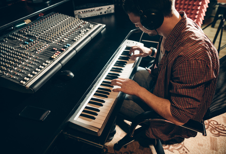man in headphones playing on the synthesixerの写真素材
