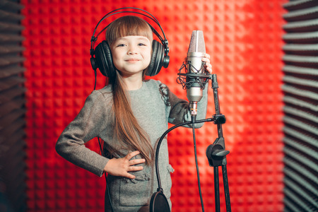 smiling happy girl in headphones is good at singingの写真素材