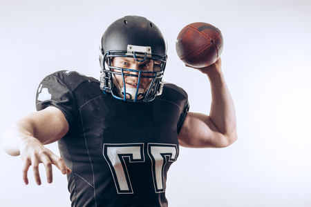 Quarterback throwing a football in a professional football gameの写真素材