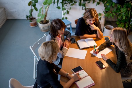Working overtime concept. Group of female business team working late at nightの写真素材